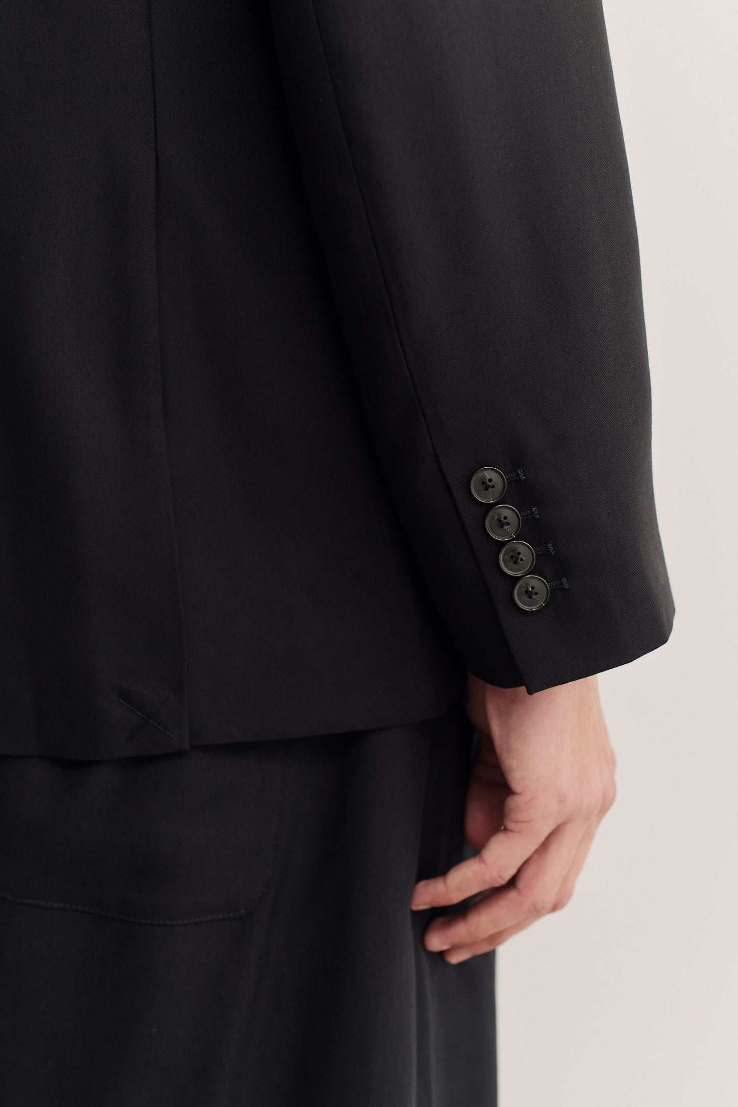 Men's tailoring, black lyocell heavy twill blazer with double-buttoned cuff detail.
