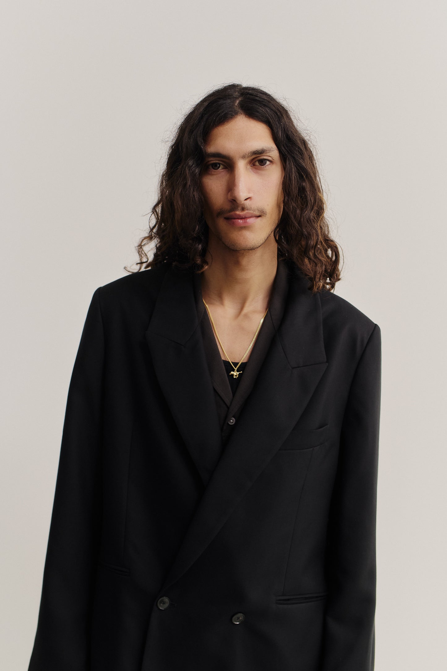 Men's tailoring, relaxed double-buttoned blazer in black lyocell twill.