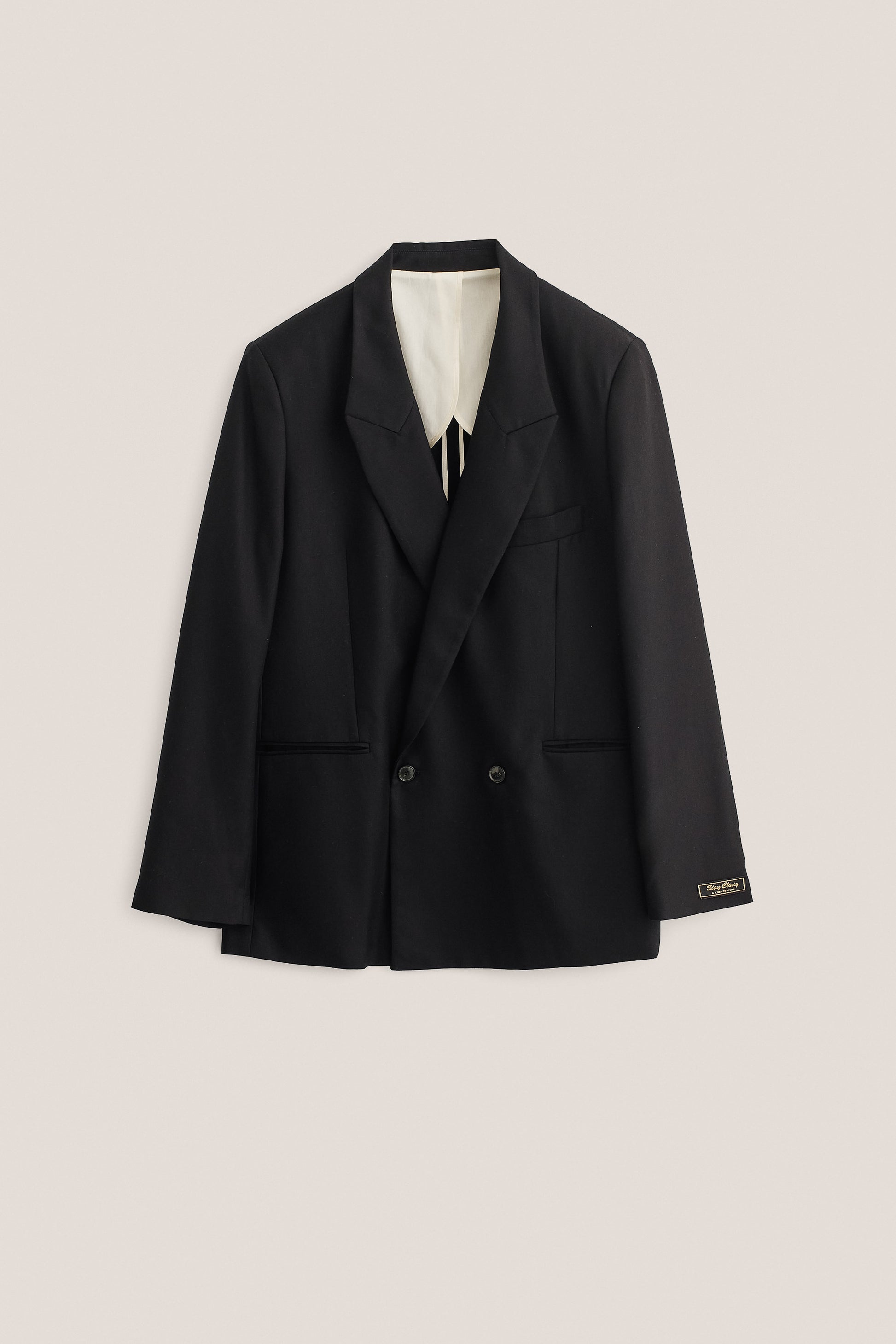 Men's tailoring, double-breasted blazer, lyocell twill, deep black, oversized fit, "stay classy" label.