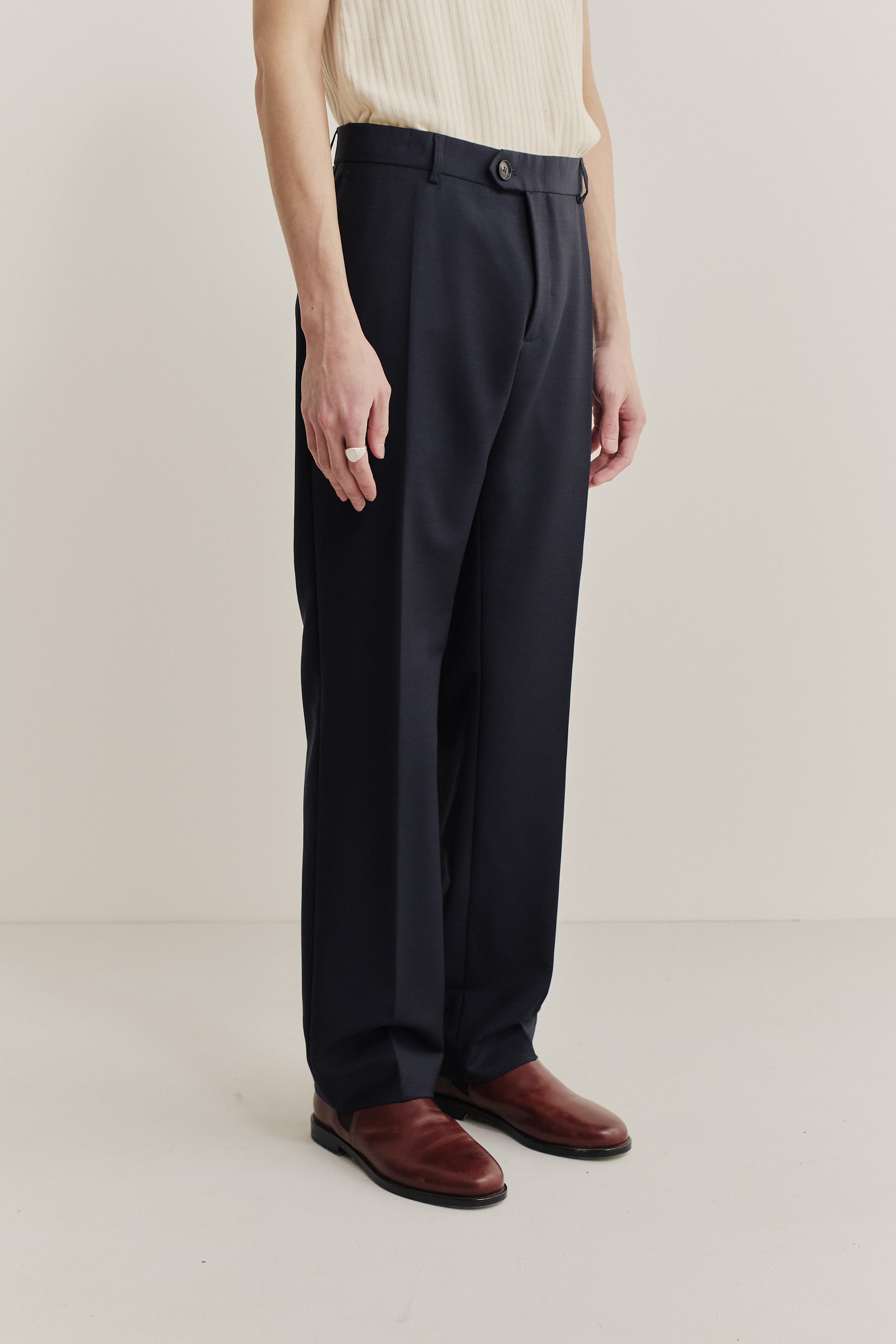 Men's long-pants, 100% virgin wool, dark navy, with a visible front button closure and pleat.