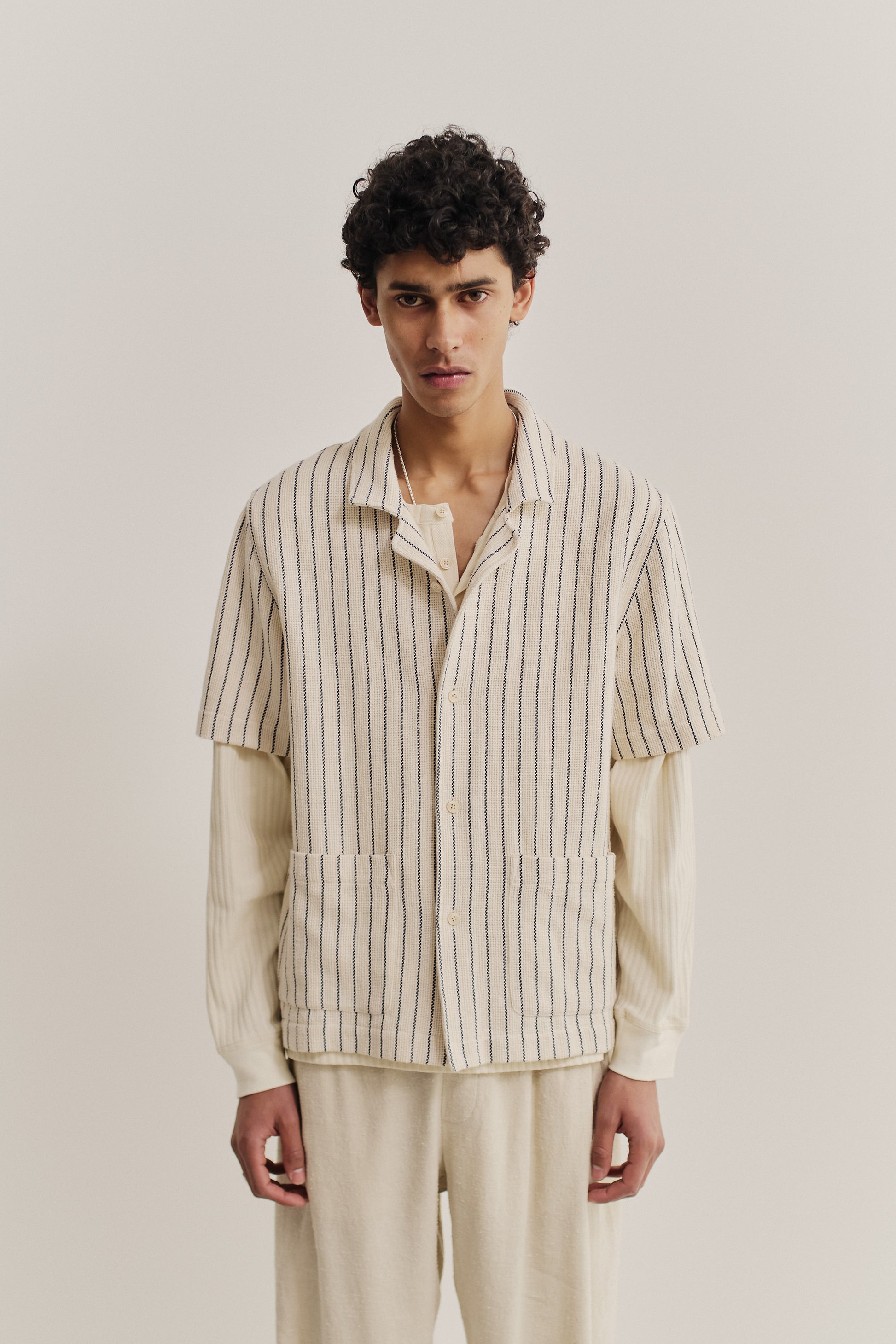 Men's short-sleeved shirt, cotton mix, off-white with navy stripes, rounded spread collar, double patch pockets.