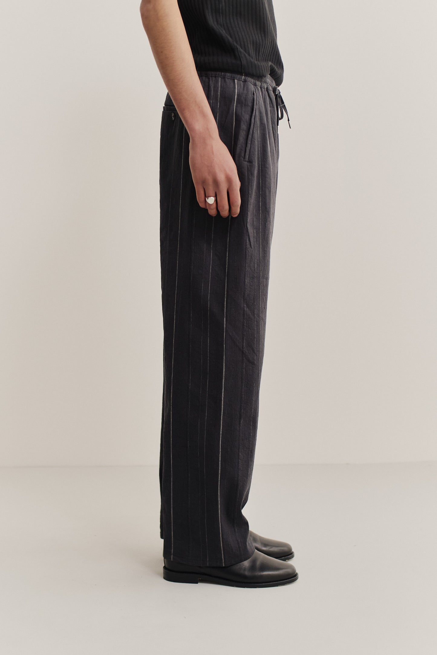 Men's long pants, cotton-linen blend, black with subtle white stripes, wide straight fit, elasticated waist.