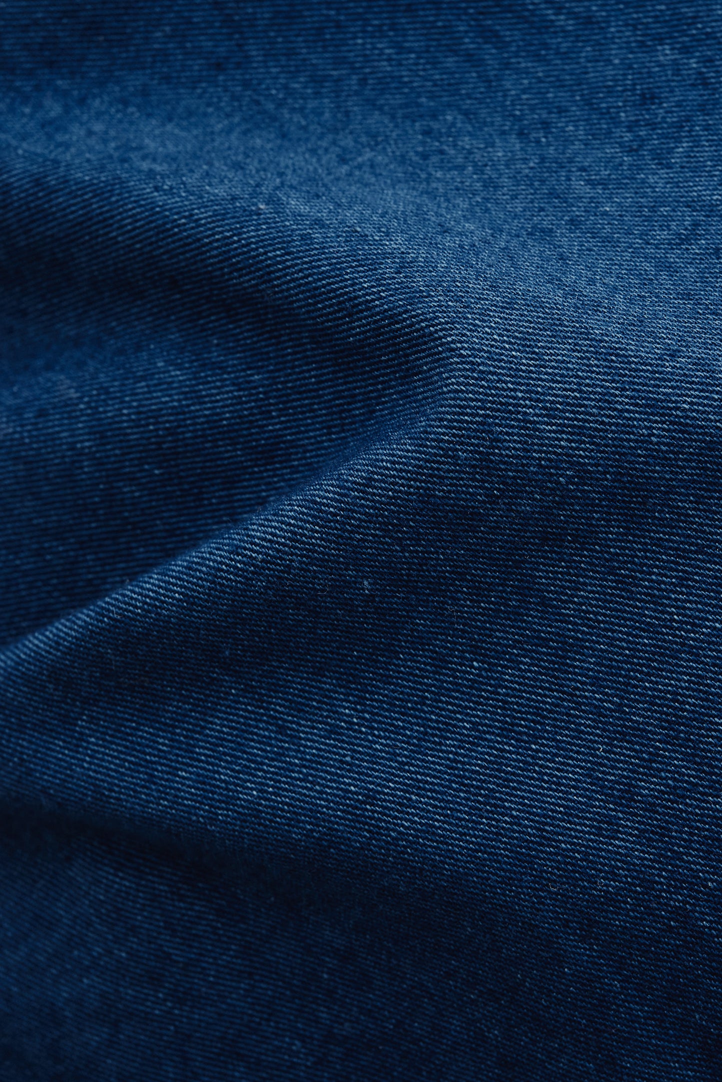 Women's long-sleeved shirt, washed indigo cotton, with a smooth, breathable texture.