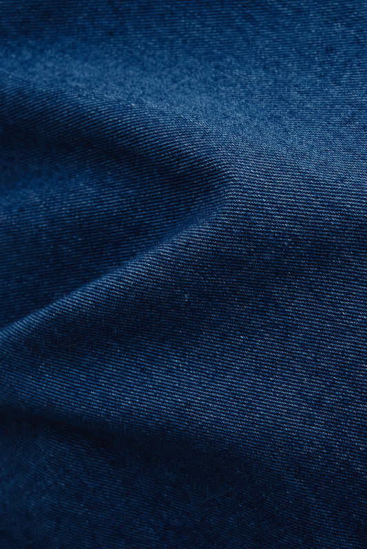 Women's long-sleeved shirt, washed indigo cotton, with a smooth, breathable texture.