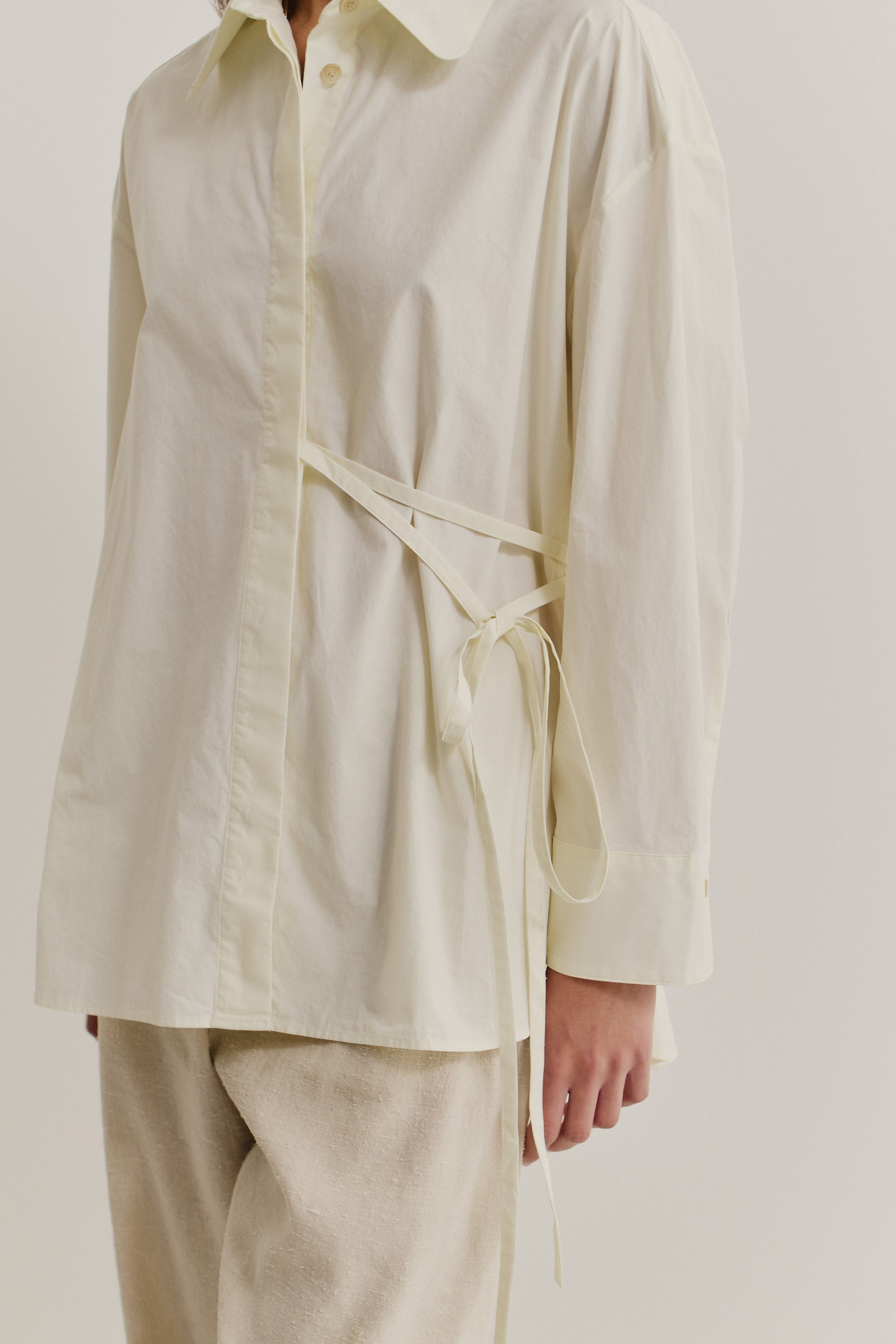 Women's long-sleeved shirt, organic cotton, garment washed, off-white, with side tie detail.