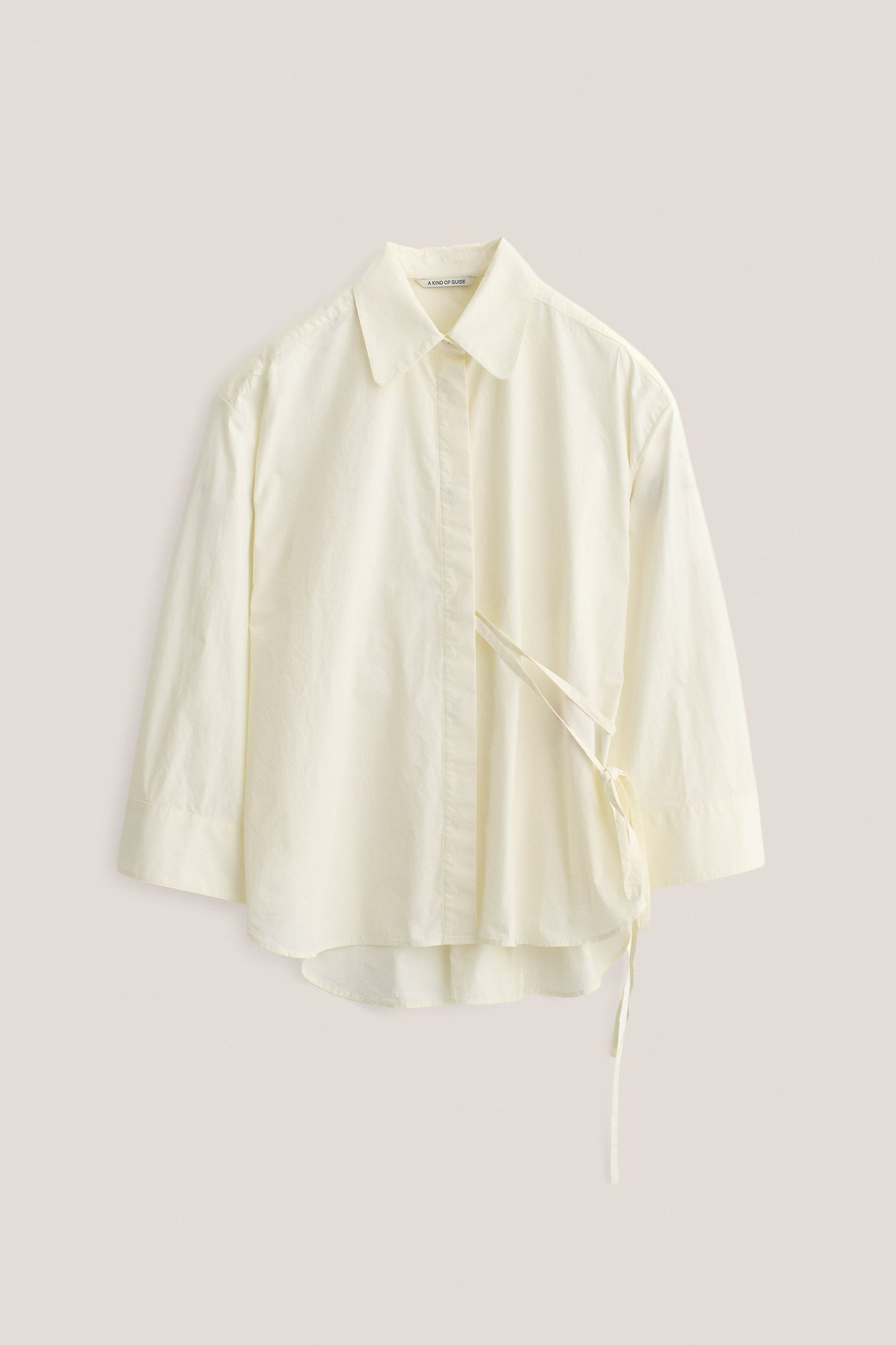 Women's long-sleeved shirt, organic cotton, garment washed, off-white, with wide oversized fit and side tie detail.