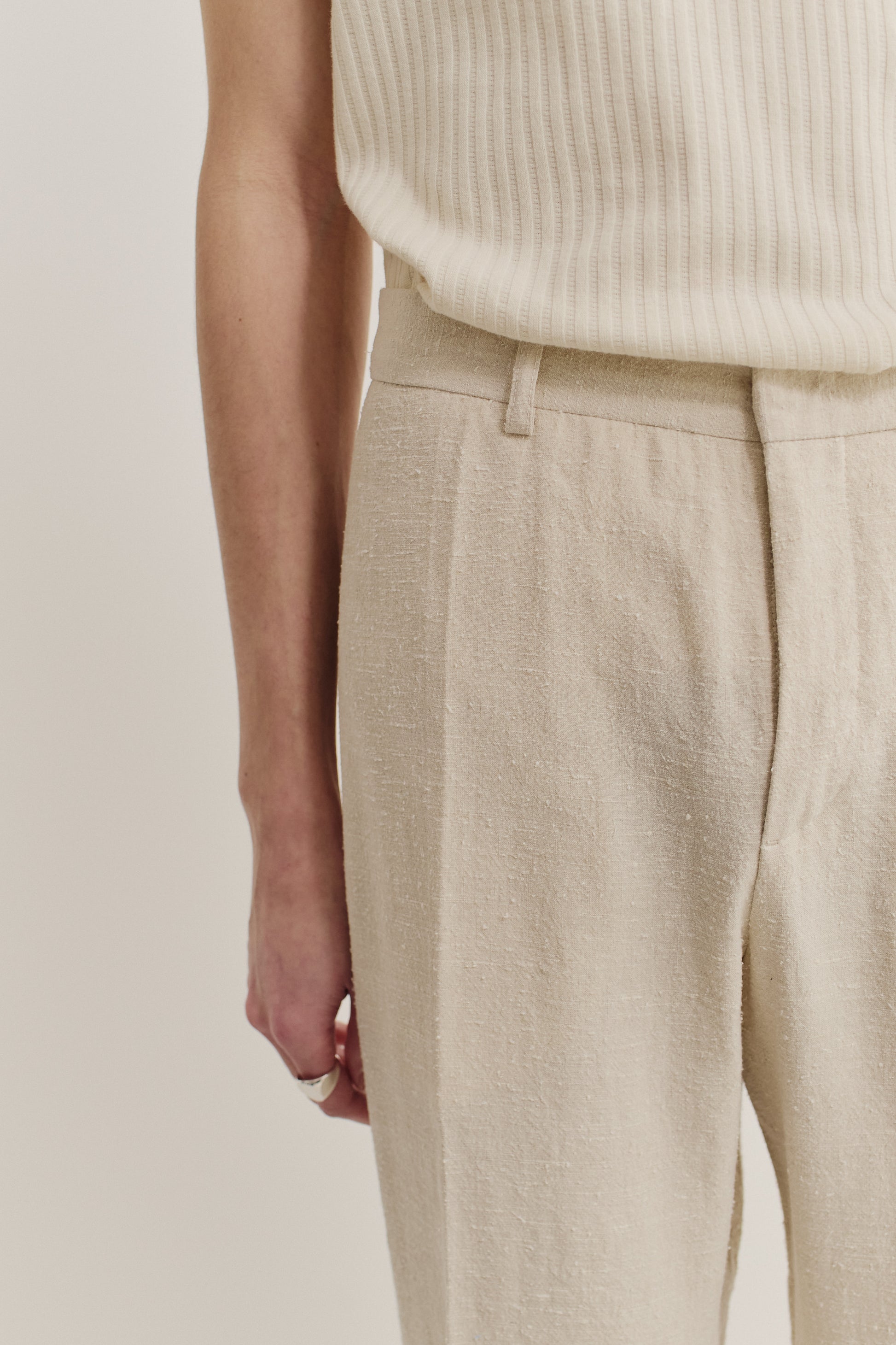 Men's long-pants, linen-silk blend, naturally textured, undyed beige, tailored wide-leg with pressed pleat.