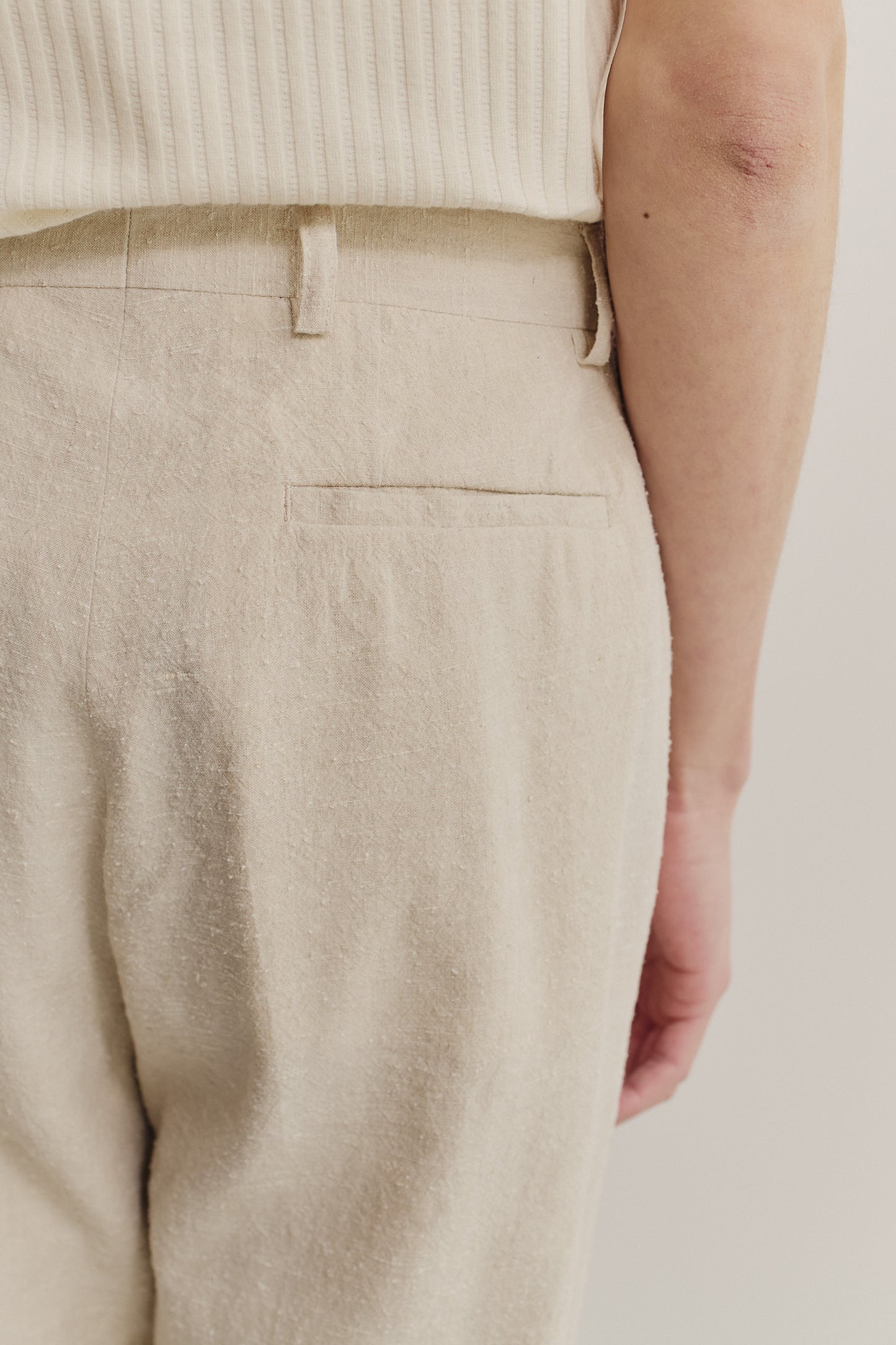 Men's long-pants, linen-silk blend, naturally textured, undyed beige, with a single back pocket.