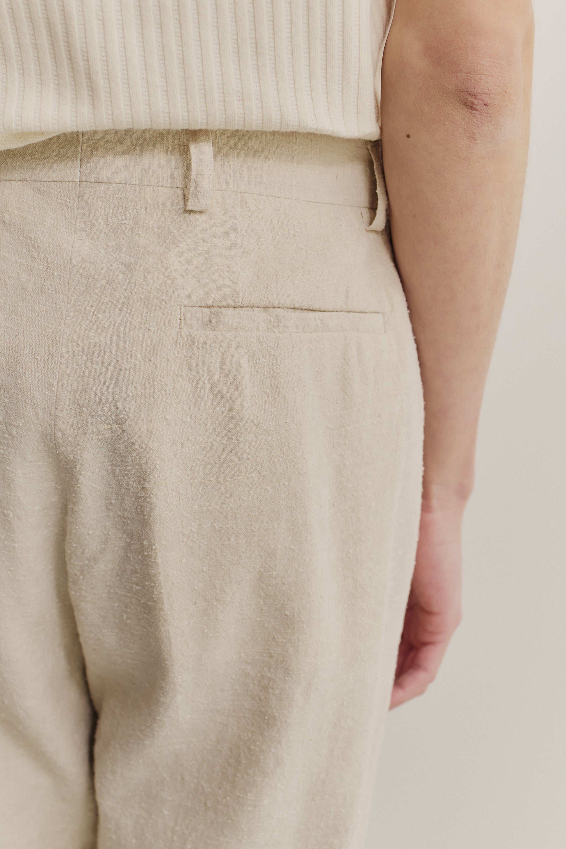 Men's long-pants, linen-silk blend, naturally textured, undyed beige, with a single back pocket.