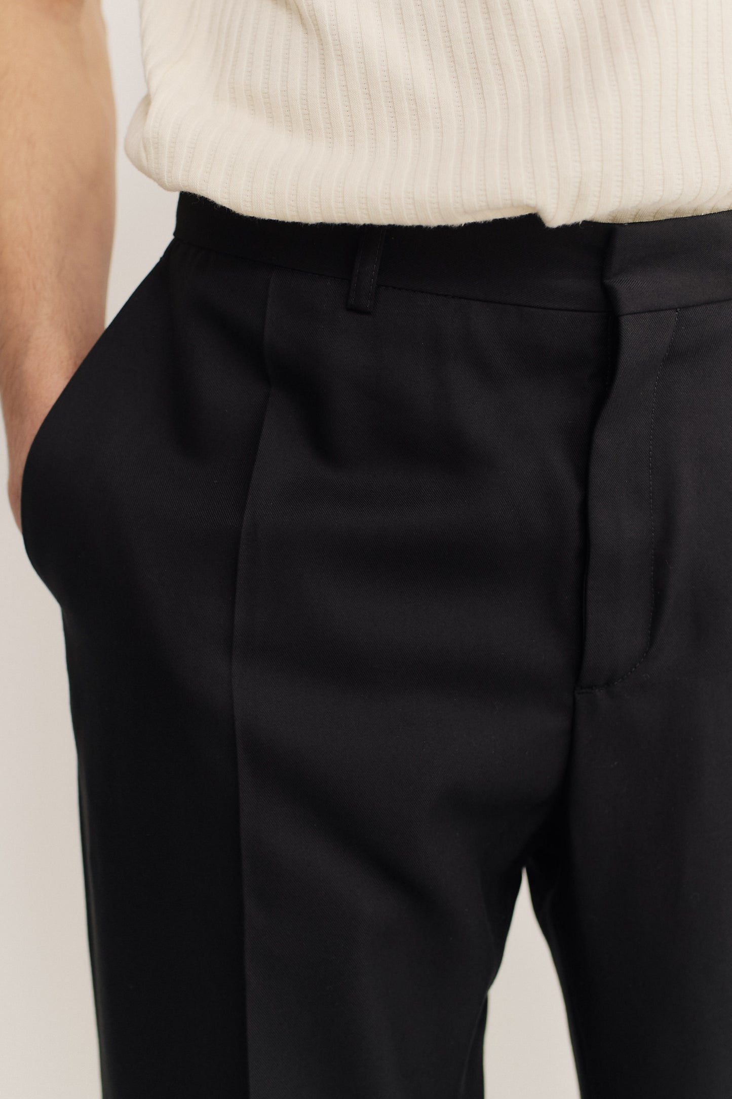 Men's long-pants, lyocell twill, deep black, tailored wide-leg cut, hidden closure, pressed front pleat.