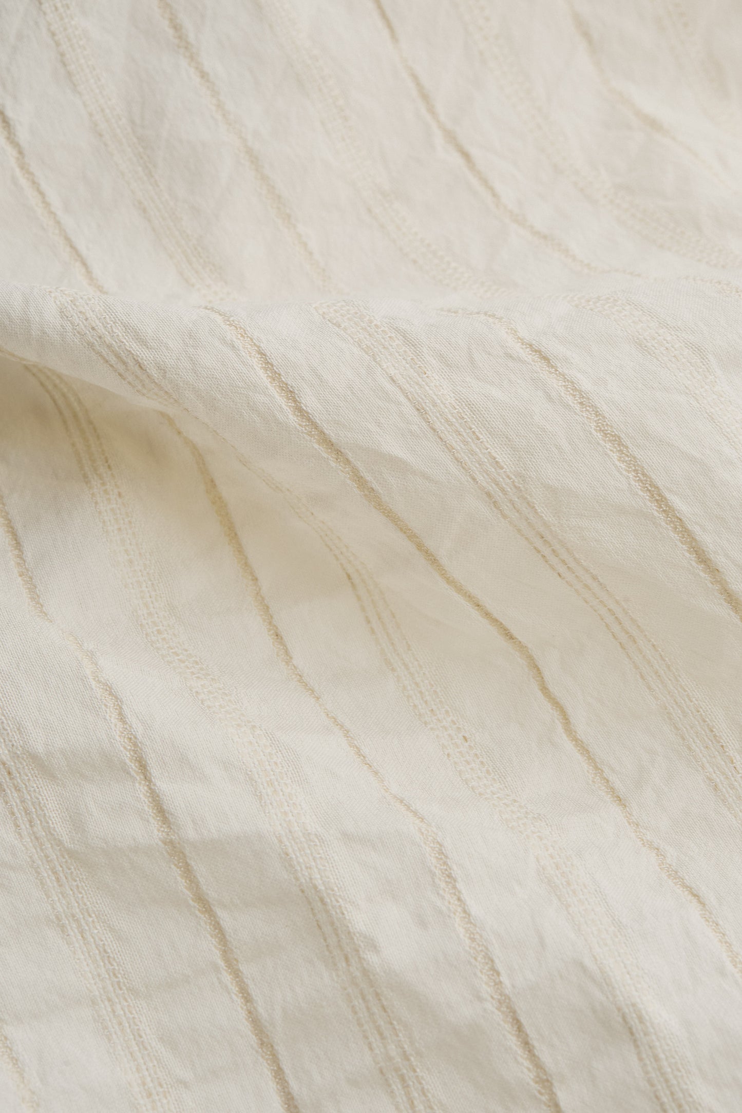 Men's short-sleeved shirt, cotton-silk-linen blend, washed finish, off-white with subtle striped texture.