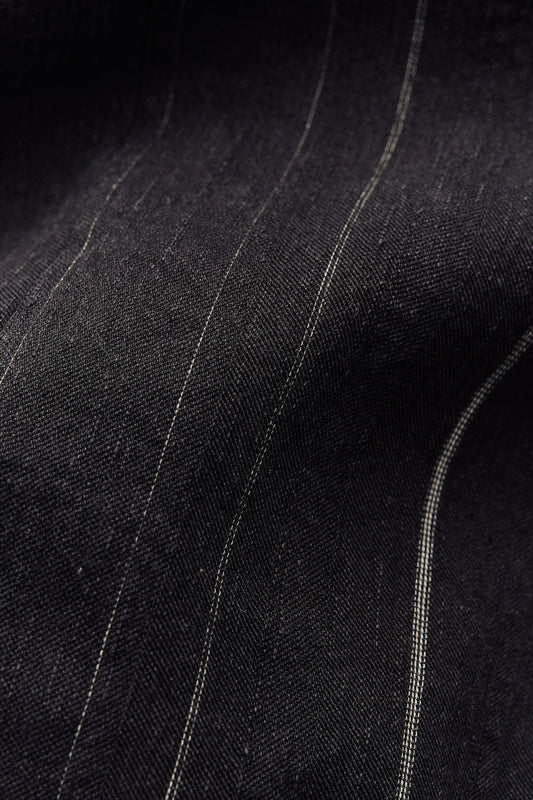 Women's jumpsuit, cotton-linen blend, black with subtle white stripes, textured, faded finish.