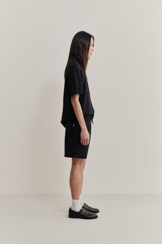 Men's shorts, cotton blend, pre-washed black, with side pockets and adjustable waistband.